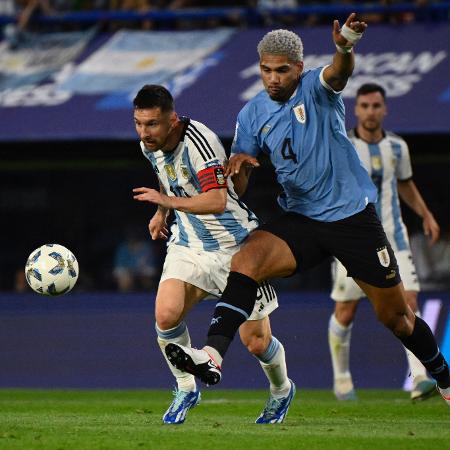 Messi, da Argentina, e Ronald Araujo, do Uruguai, disputam bola no jogo das Eliminatórias