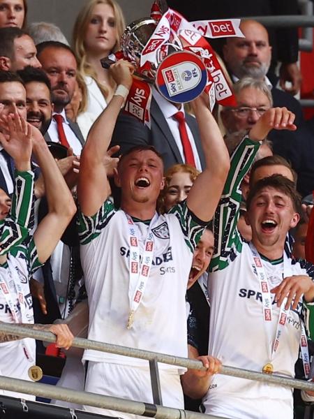 Jogadores do Sunderland levantam a taça do vencedor do playoff da Championship Jogadores do Sunderland levantam a taça do vencedor do playoff da Championship