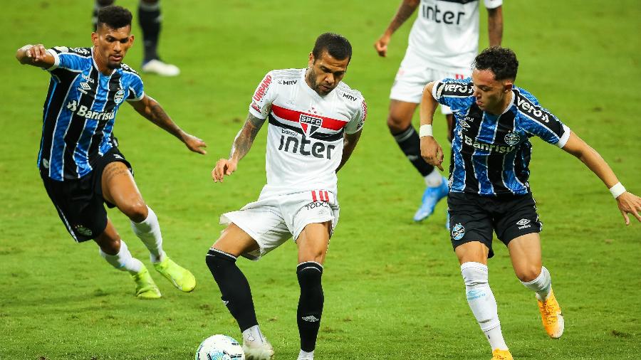 Daniel Alves, do São Paulo, em lance com Pepê e Rodrigues, do Grêmio, pelo Campeonato Brasileiro de 2020 - Pedro H. Tesch/AGIF