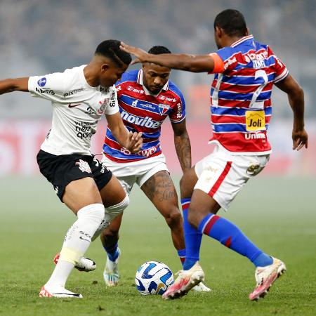 Jogadores de Corinthians e Fortaleza em ação durante partida disputada em 2023 - Paulo Pinto / AFP