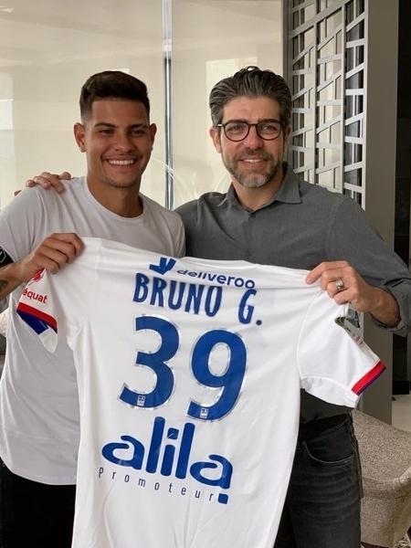 Juninho Pernambucano entrega a camisa 39 do Lyon a Bruno Guimarães - @JM_Aulas/Twitter