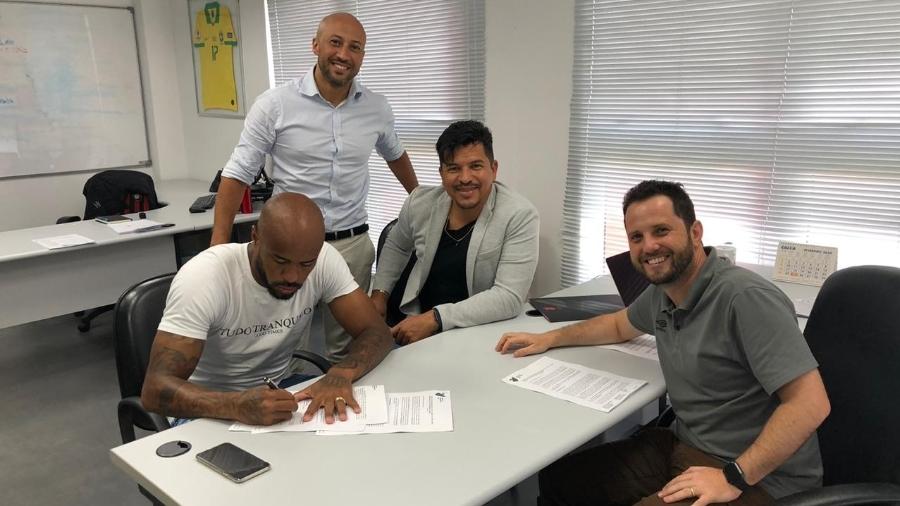 Thiago Heleno assina o contrato de renovação com Athletico-PR ao lado dos diretores do clube Rafael Andrade e Rodrigo Gama Monteiro e seu empresário, Giba Brasil - Divulgação