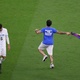 A fan invades the field with an LGBTQIA+ flag during a match between Uruguay and Portugal - MIchael Steele/Getty Images