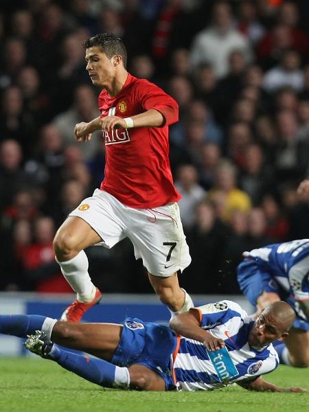 Fernando Reges (no chão), do Porto, desarma Cristiano Ronaldo, à época no Manchester United, em jogo da Liga dos Campeões de 2009 - Matthew Peters/Manchester United via Getty Images