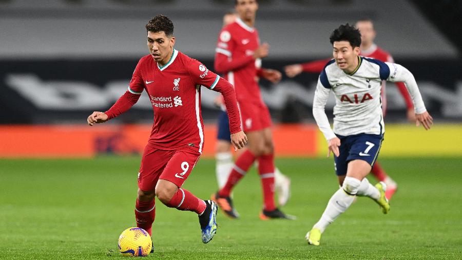Roberto Firmino dispara à frente de Heung-Min Son durante partida entre Tottenham e Liverpool - Shaun Botterill/Getty Images
