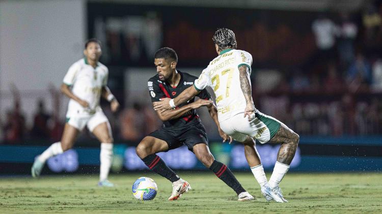 Rhaldney, do Atlético-GO, encara marcação de Richard Ríos, do Palmeiras, em partida pela 35ª rodada do Brasileirão