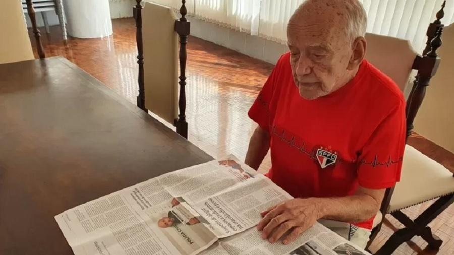 O comerciante aposentado Álvaro Pereira vê no jornal onde vão passar os jogos do São Paulo - Thais Carrança/BBC Brasil