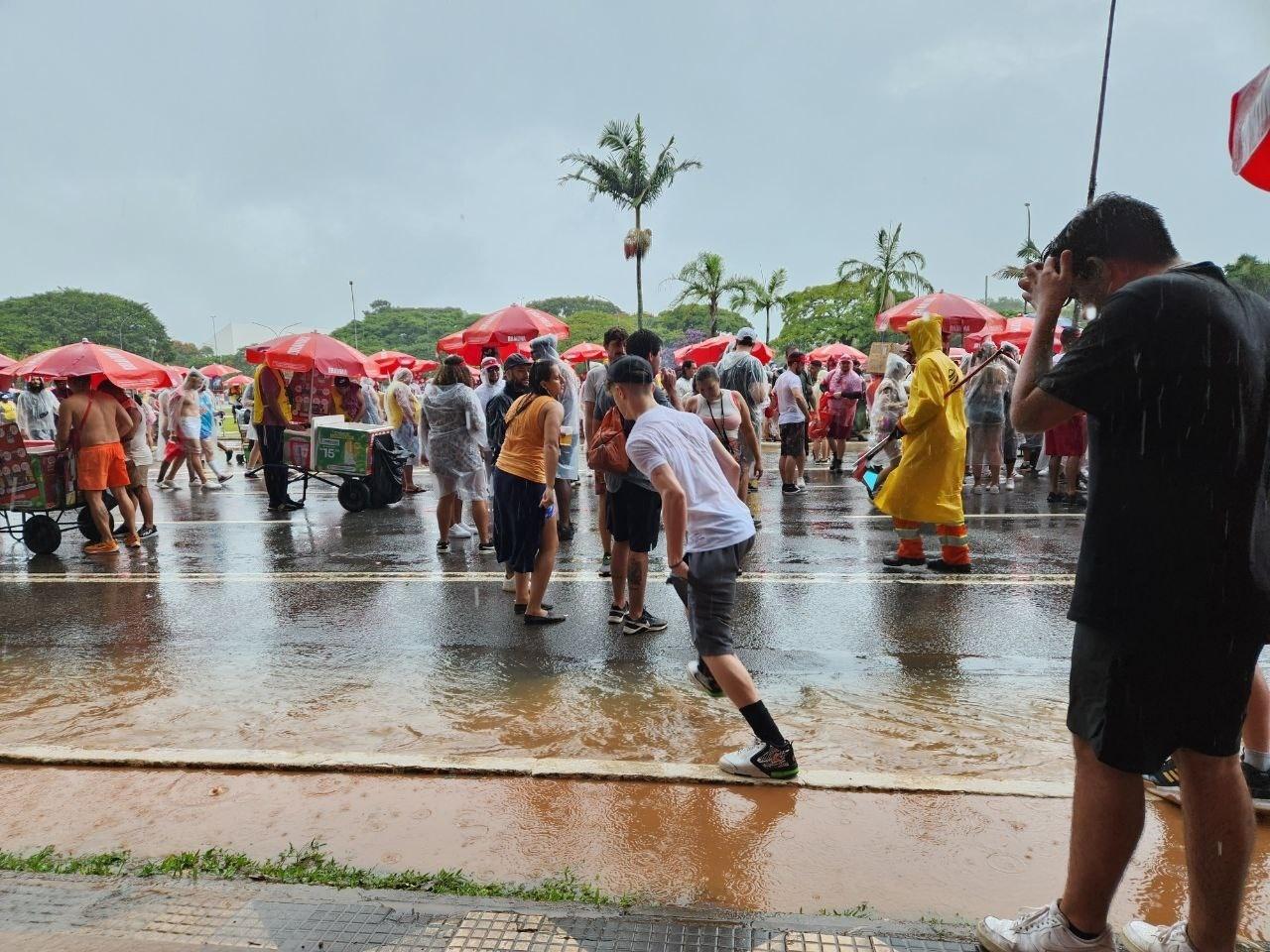Foliões tentam driblar poças de água pelo caminho - Camila Corsini/UOL