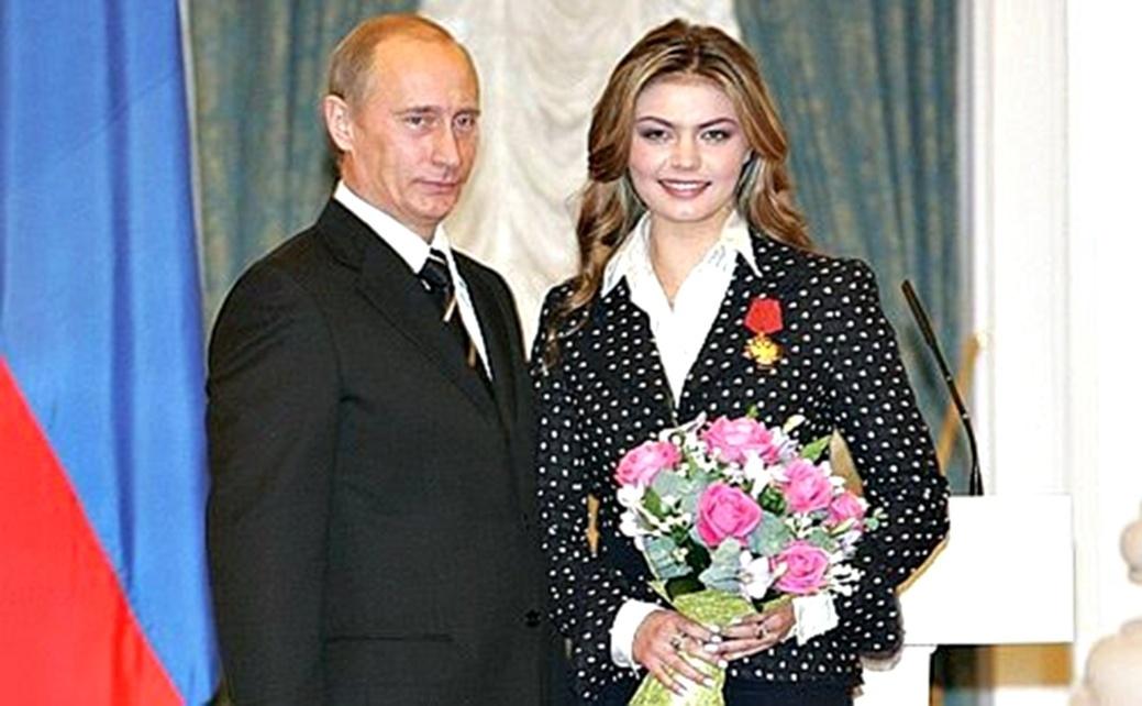 Russian President Vladimir Putin presents his award to gymnast Alina Kabaeva