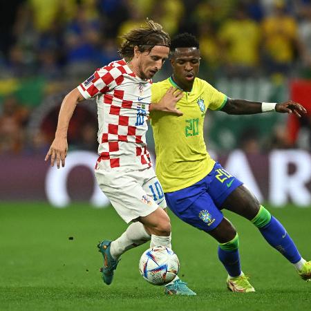 Vinicius Jr. e Modric disputam a bola durante Brasil x Croácia na Copa-2022