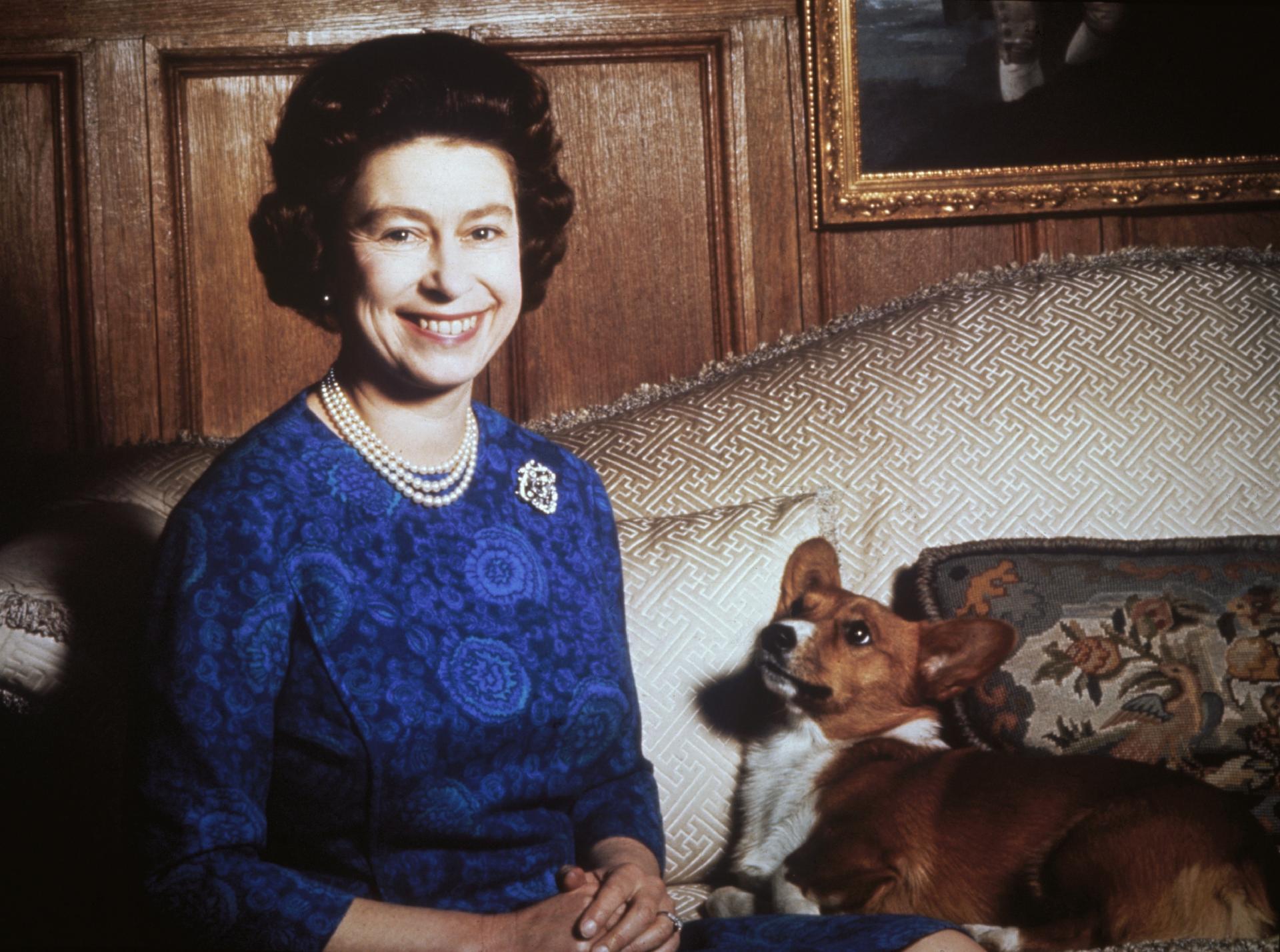 Queen Elizabeth II with a corgi in 1970 - Getty Images