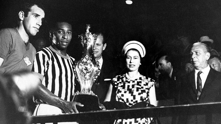 A Rainha da Inglaterra, Elizabeth 2º, ao lado do Príncipe Phillip, se encontram com Pelé, com o troféu em mãos, durante visita da monarca ao país A Rainha da Inglaterra, Elizabeth 2º, ao lado do Príncipe Phillip, se encontram com Pelé, com o troféu em mãos, durante visita da monarca ao país