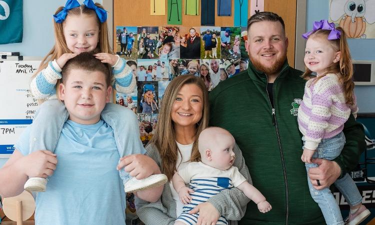 O bebê reunido com os pais e os irmãos no hospital O bebê reunido com os pais e os irmãos no hospital