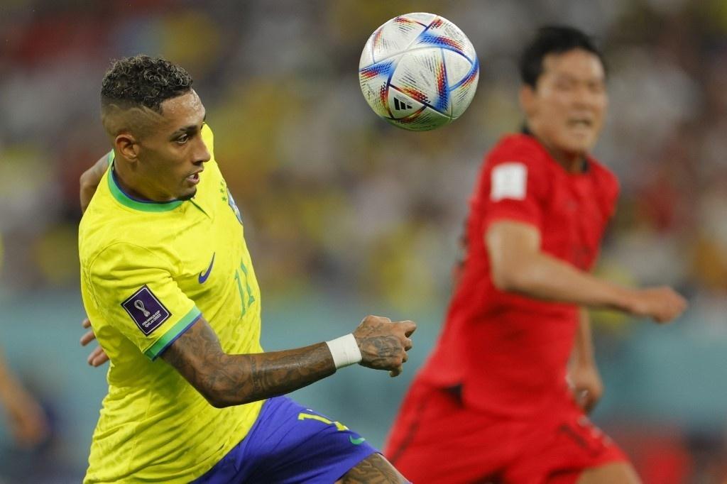 Raphinha handles the ball in a match between Brazil and South Korea - Odd Anderson/AFP