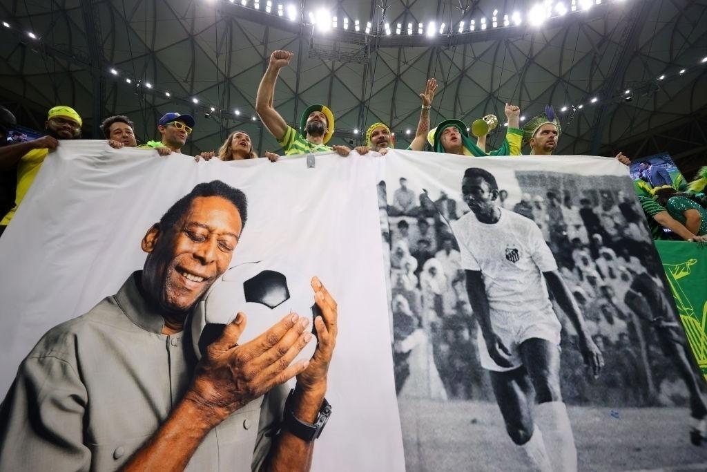 Brazil fans pay tribute to Pele before the match against Cameroon in the World Cup - Richard Heathcote/Getty Images