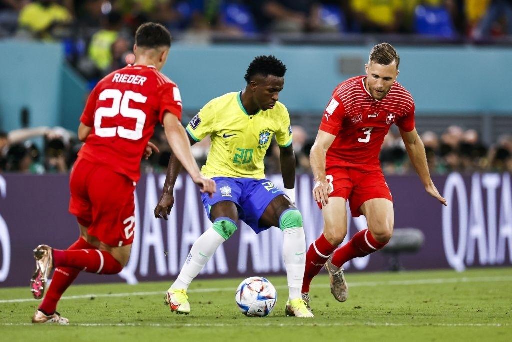 Vinicius Jr.  in the middle of two markers during a match between Brazil and Switzerland - ANP via Getty Images