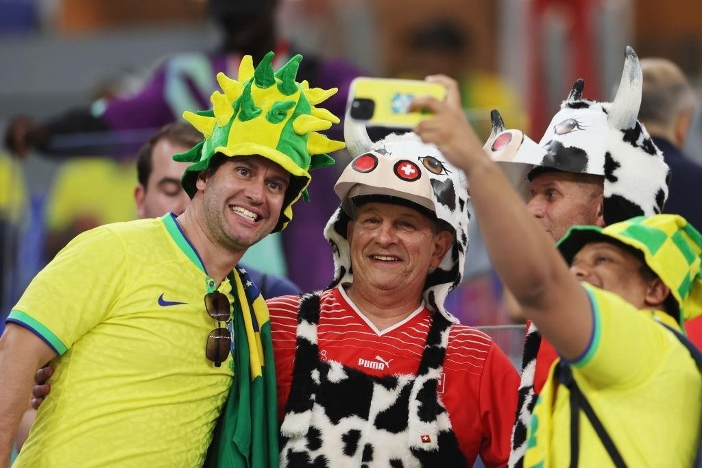 Brazilians and Swiss pose together for a photo before the match between the teams at the World Cup - Catherine Ivill/Getty Images