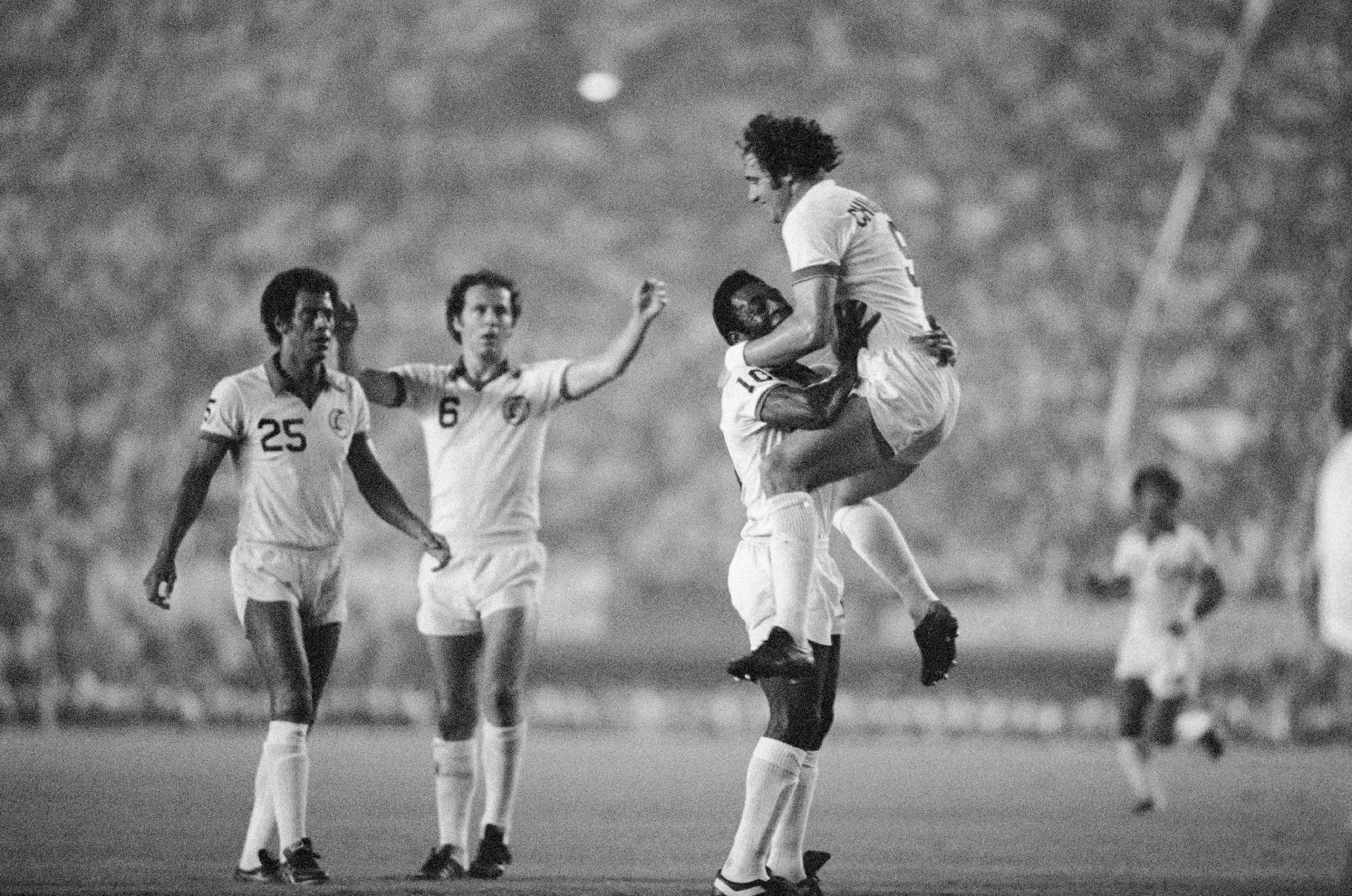 Pelé ergue Giorgio Chinaglia após o colega marcar o primeiro gol do NY Cosmos no jogo ''Pelé Sayonara", disputado no Estádio Nacional do Japão. O time norte-americano venceu o asiático All-Star por 3 a 1. - Bettmann/Bettmann Arquivo