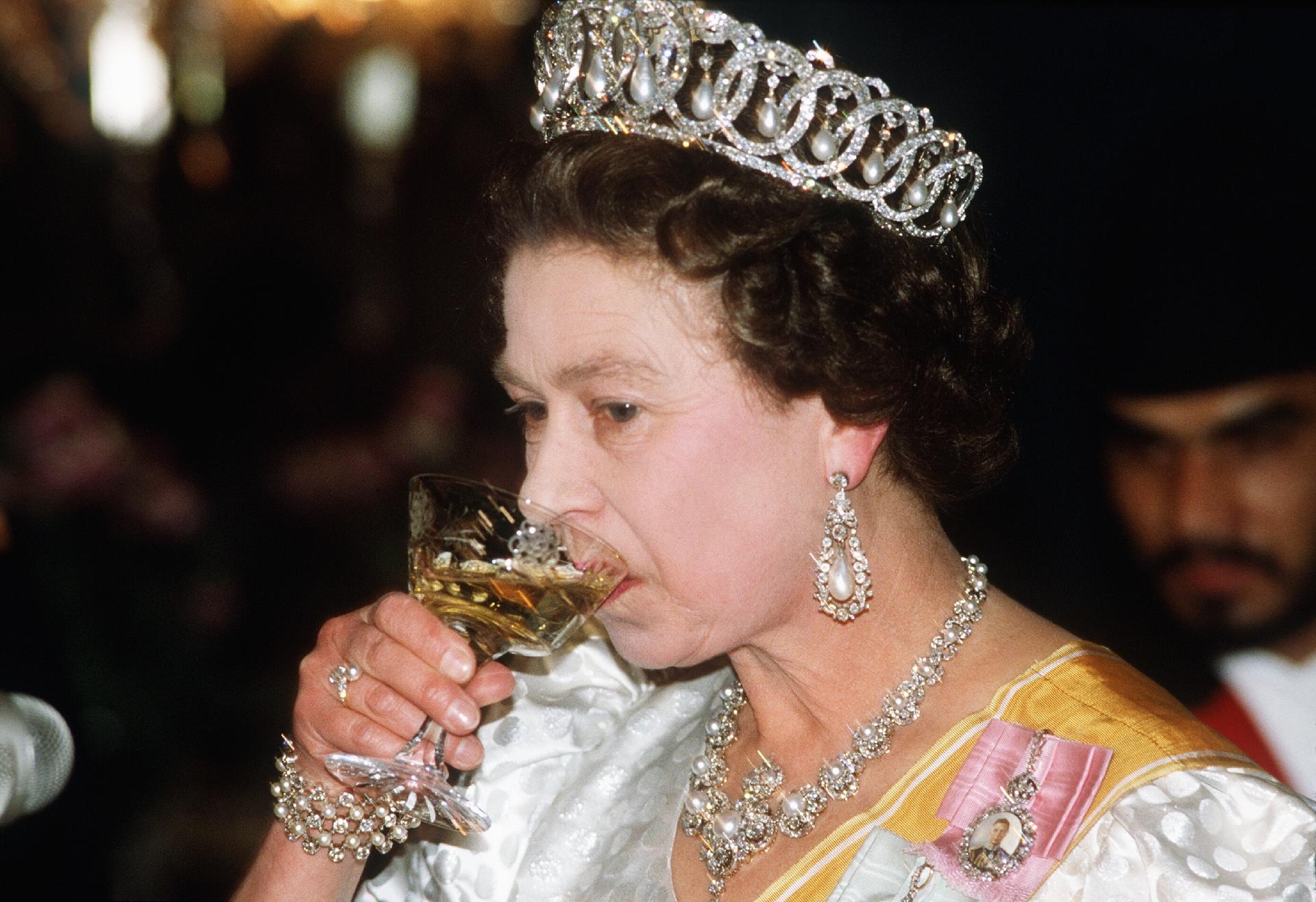 Queen  Elizabeth toasting at a banquet in Nepal in 1969 - Getty Images