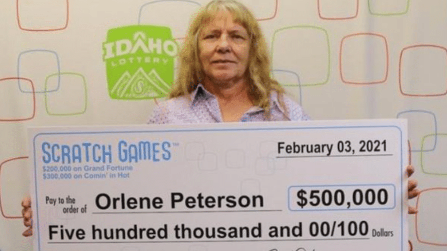 Orlene segurando um cheque simbólico com o prêmio ganho em dois dias - Divulgação/Loteria de Idaho