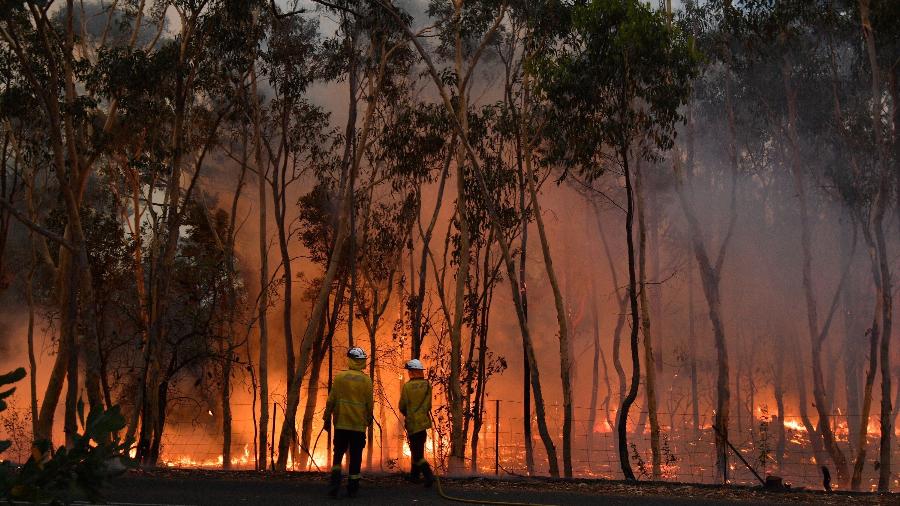 7.dez.2019 - Bombeiros atuam no combate a incêndios, na Austrália, em região a cerca de 100 km da capital Sydney - Saeed Khan/AFP
