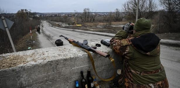 06.mar.2022 - Soldado da Ucrânia em posto de controle antes da última ponte na estrada que liga Stoyanka a Kiev