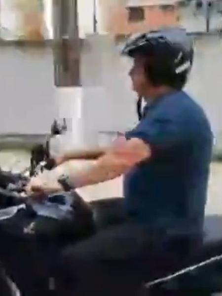 Bolsonaro anda de moto pelo Guarujá com capacete não afixado à cabeça - Reprodução