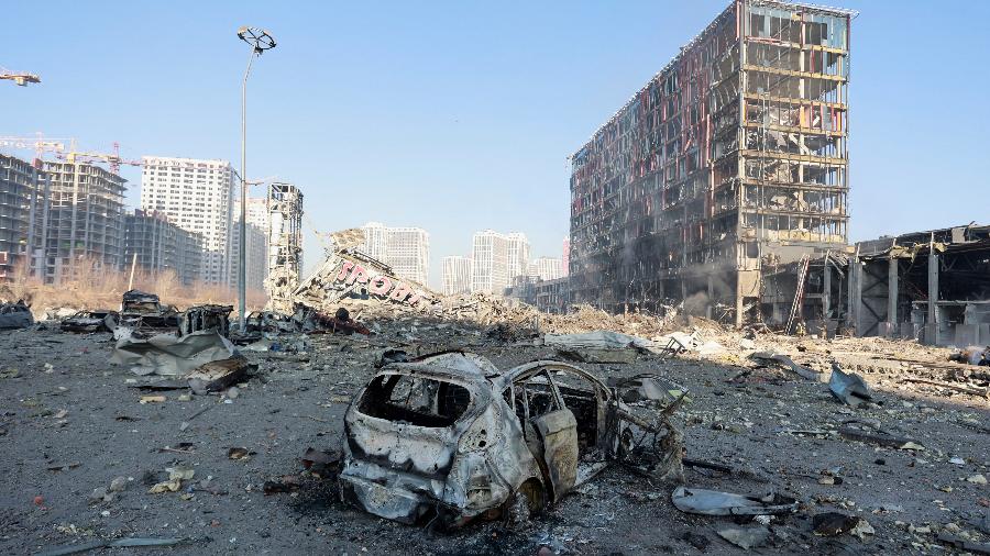 21.mar.2022 - Carro destruído em local de bombardeio a shopping no distrito de Podilskyi, em Kiev - REUTERS/Serhii Nuzhnenko