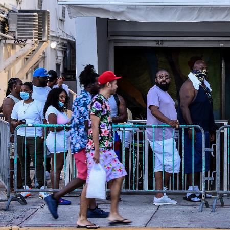 26.jun.2020 - Moradores da Flórida (EUA) fazem fila para entrar em restaurante em Miami Beach, na Ocean Drive - Chandan Khanna/AFP