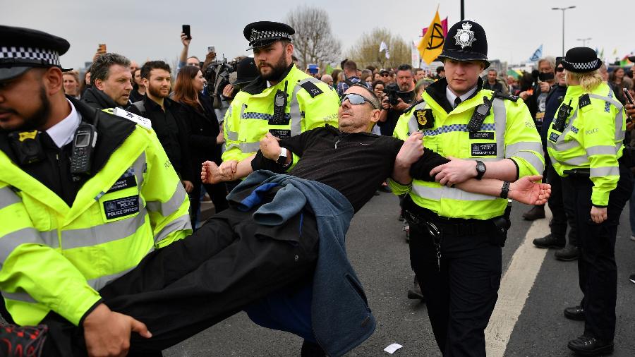 16.abr.2019 - Polícia britânica carrega ativista detido no segundo dia de protestos contra mudanças climáticas em Londres - Ben Stansall/AFP Photo