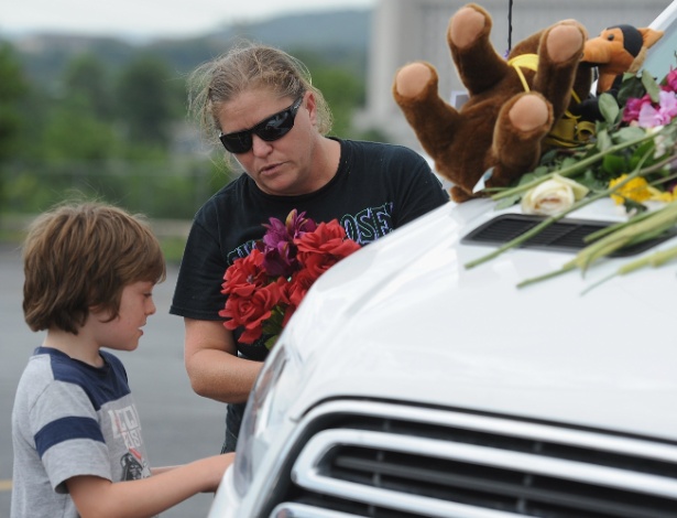 Família coloca flores em veículo de vítimas do acidente com embarcação no Missouri - Michael Thomas/Getty Images/AFP