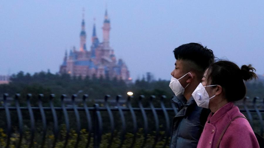 Visitantes usam máscaras na Disneylândia em Xangai, na China - Aly Song