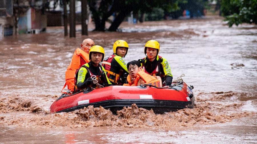 Moradores são resgatados de bote em rua alagada em Chongqing, na China - 4.jul.2023 - cnsphoto via Reuters