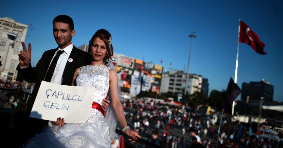 9.jun.2013 - Casal recém-casado posa com um cartaz onde se lê 