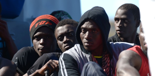 Imigrantes chegam em um barco das Forças Armadas de Malta após serem transferidos de navio - Matthew Mirabelli/AFP