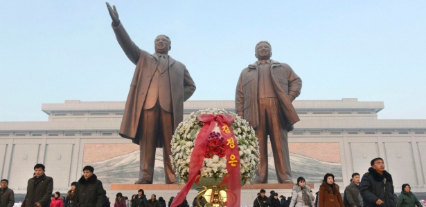 Norte-coreanos depositam flores em estátuas de bronze dos líderes da Coreia do Norte (já falecidos), Kim Il Sung e Kim Jong Il --respectivamente avô e pai do atual ditador, Kim Jon-un