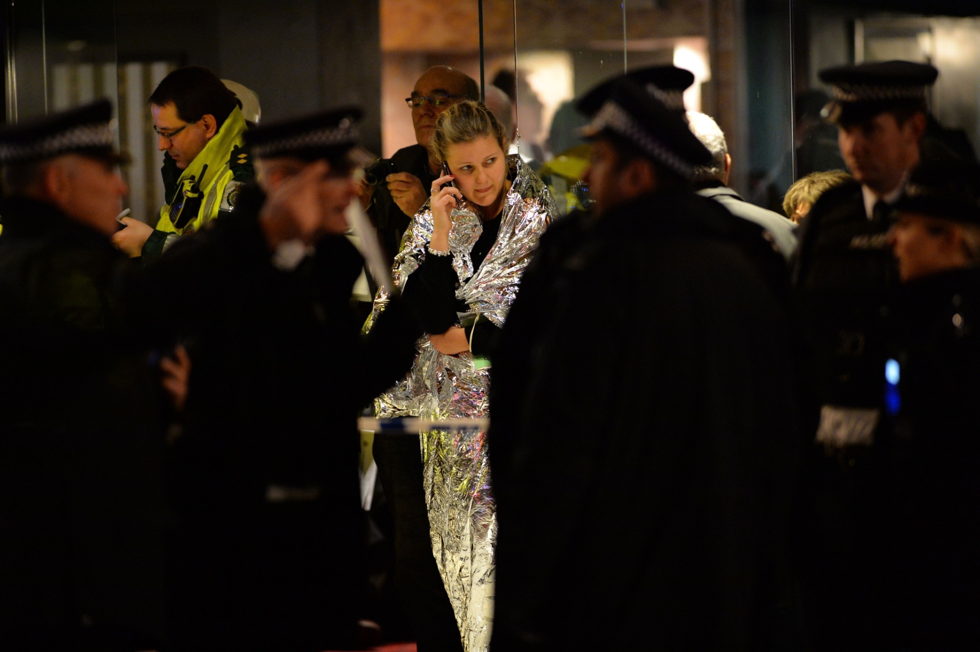 19.dez.2013 - Vítima do desabamento de parte do teto do teatro Apollo, em Londres (Inglaterra), ligam para familiares. O acidente ocorreu por volta de 20h15 no horário local (18h15 em Brasília) durante uma apresentação com casa cheia - Leon Neal/AFP