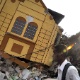 13.jan.2010 - Haitiano caminha em frente aos destroços de uma casa afetada pelo terremoto que atingiu o país em janeiro de 2010 e chegou a 7.0 na escala Richter - Juan Barreto/AFP