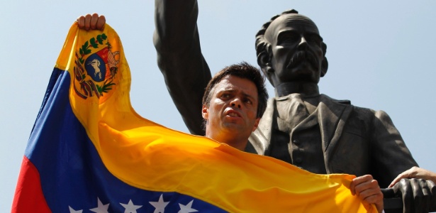 Leopoldo López, ardoroso opositor do governo da Venezuela, segura a bandeira do país antes de ser preso