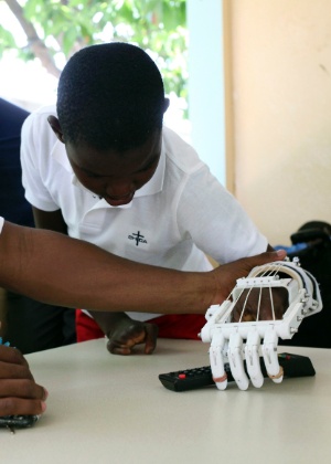 Stevenson Joseph, 12, aprende a usar mão protética no orfanato onde vive, no Haiti  - Marie Arago/Reuters