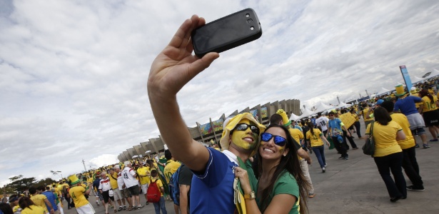 Torcedores fazem selfie em frente ao Mineirão (Belo Horizonte), antes da partida entre Brasil e Alemanha, em 2014 - Adrian Dennis/AFP