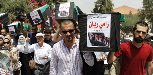 Agosto: jornalistas carregaram caixões simbólicos lembrando colegas mortos em Gaza - Abbas Momani/AFP