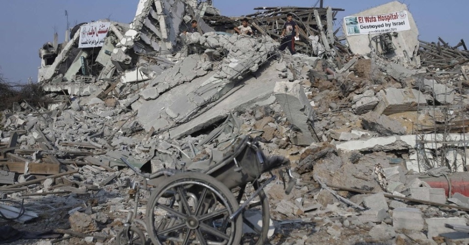 28.ago.2014 - Cadeira de rodas aparece, nesta quinta-feira (28), em meio aos escombros de hospital de reabilitação de El-Wafa, que foi destruído durante a ofensiva israelense em Gaza. Os pacientes que recebiam tratamento no hospital foram transferidos para outra unidade, disseram autoridades
