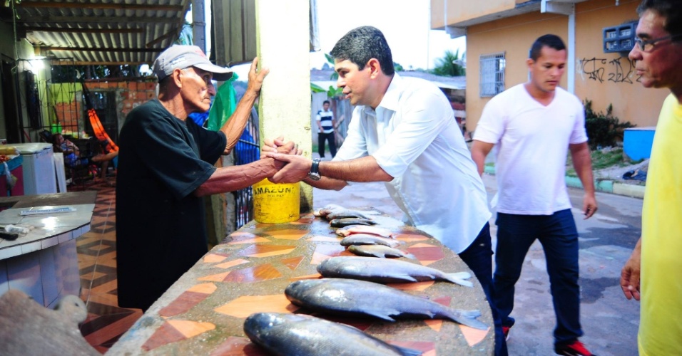 26.ago.2014 - Marcelo Ramos (esq.), candidato ao governo do Amazonas pelo PSB, visita mercado e cumprimenta comerciante durante campanha eleitoral