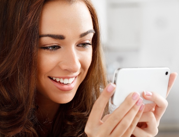 Adolescente usa celular para ver mensagens: mais sujo do que banheiro, segundo especialistas - Fotolia