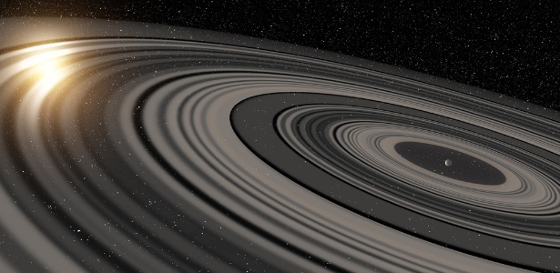 Concepção artística do sistema de anéis extrassolares circundando o jovem planeta ou anã marrom J1407b. Os anéis são mostrados eclipsando a estrela J1407, como teria sido avistado pelo observatório SuperWASP no início de 2007  - Reprodução/Ron Miller