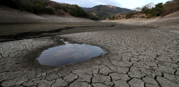 28.jan.2014 - Poça de água se destaca em meio ao solo seco e rachado no fundo da represa Alamden em San Jose, na California, EUA - Justin Sullivan/Getty Images/AFP