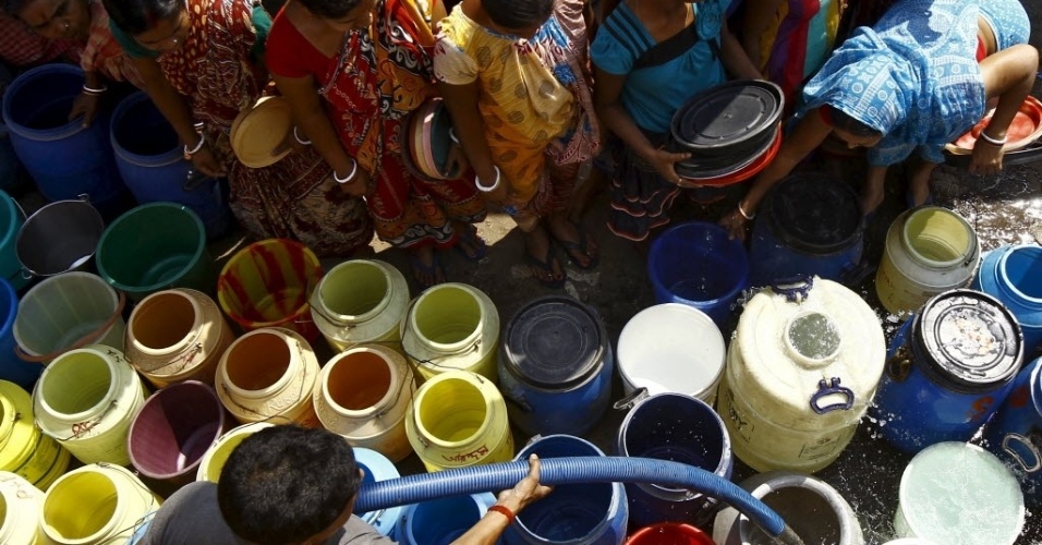 22.mar.2015 - Em Calcutá, moradores esperam até que um funcionário da prefeitura encha seus recipientes com água potável, no dia em que se comemora o Dia Internacional da Água