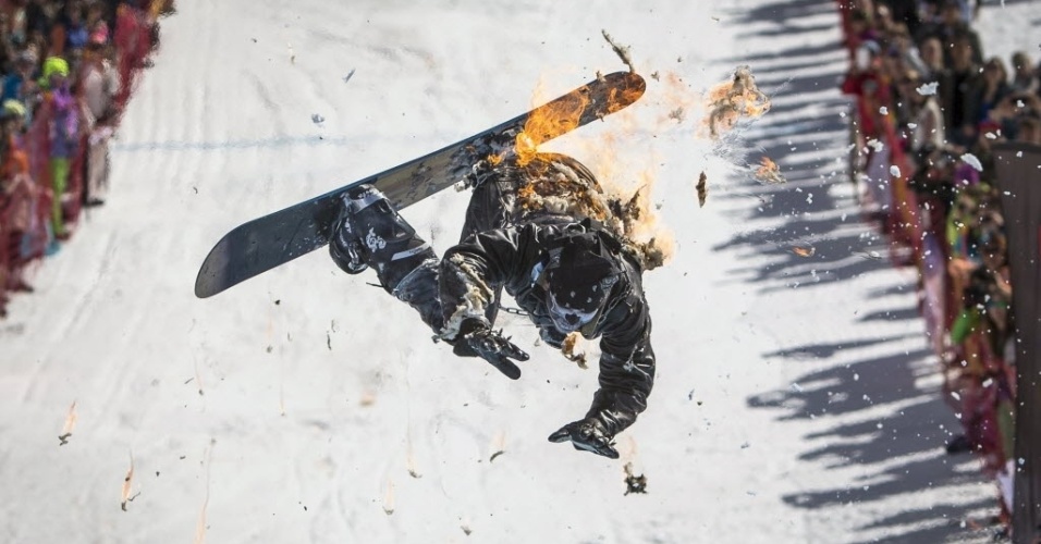 22.mar.2015 - Imagem captura o momento em que um atleta queima em queda livre, depois de passar por um arco de fogo e antes de cair em uma piscina, durante um evento do Red Bull no Cazaquistão