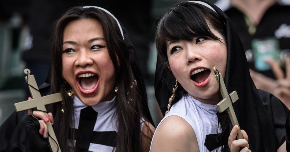 27.mar.2015 - Duas torcedoras chinesas se divertem no primeiro dia do torneio de rugby Sevens em Hong Kong, na China